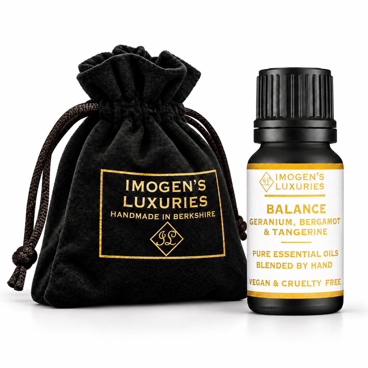 A bottle of Imogen's Luxuries 'Balance' essential oil blend next to a black velvet drawstring pouch with a gold logo patch, on a white background. Label on bottle says " BALANCE GERANIUM, BERGAMOT & TANGERINE PURE ESSENTIAL OILS"