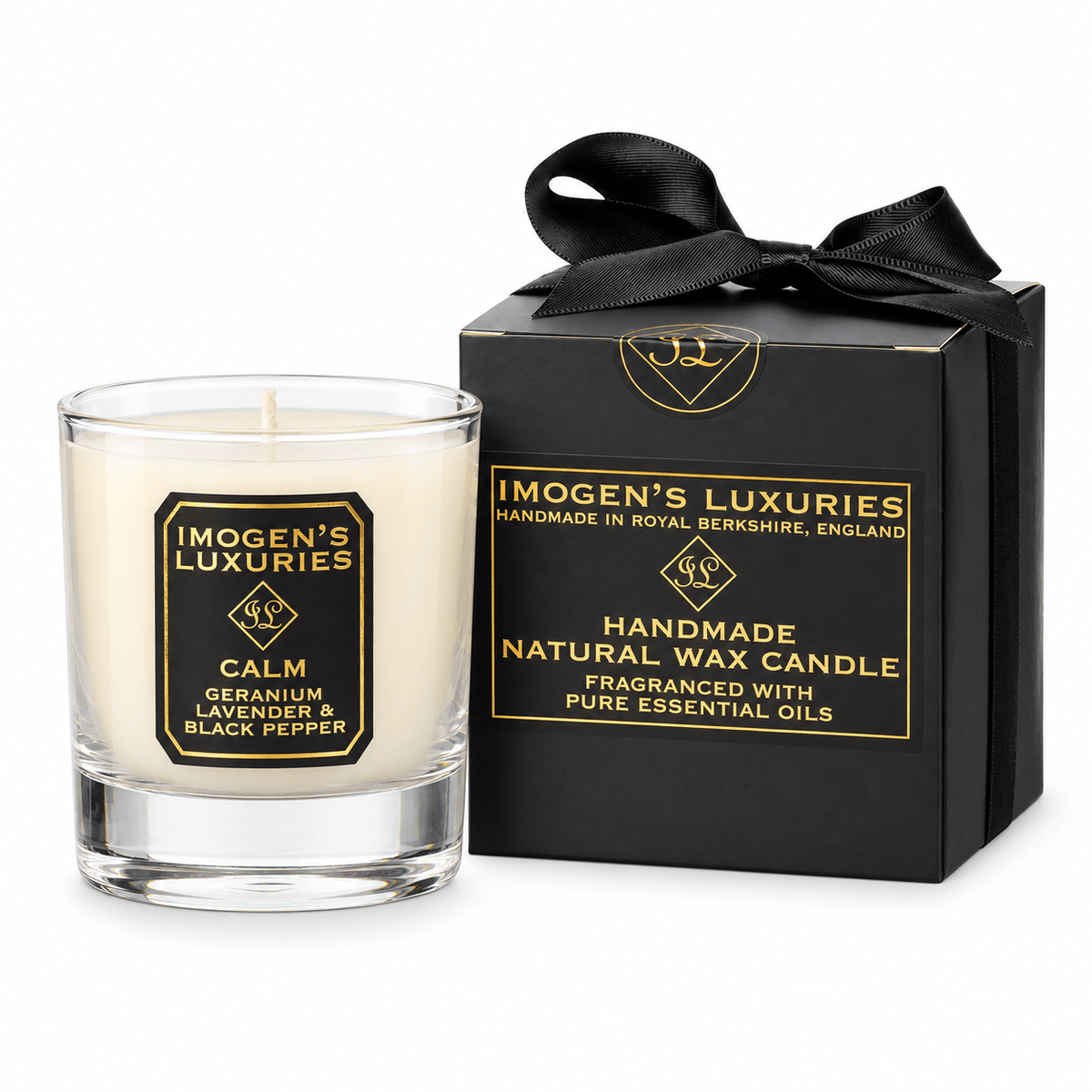 A glass container candle with natural cream coloured wax scented with Geranium, Lavender & Black Pepper Essential Oils. Candle has black and gold label and sits by a bespoke black and gold gift box with a satin bow.