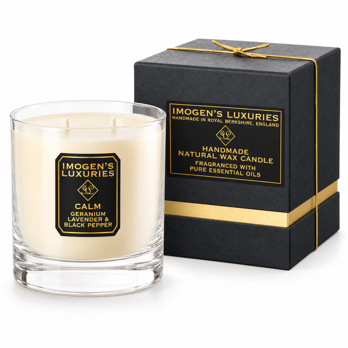 Cream coloured natural wax candle in glass container. Candles is scented with Geranium, Lavender and Black Pepper Essential Oils. On the glass container is a black and gold label saying "Imogen's Luxuries" "Calm". The candle sits by a solid black and gold shoulder box with a black and gold label saying "Handmade Natural Wax Candle fragranced with pure essential oils. Box has a gold elasticated bow on the top.