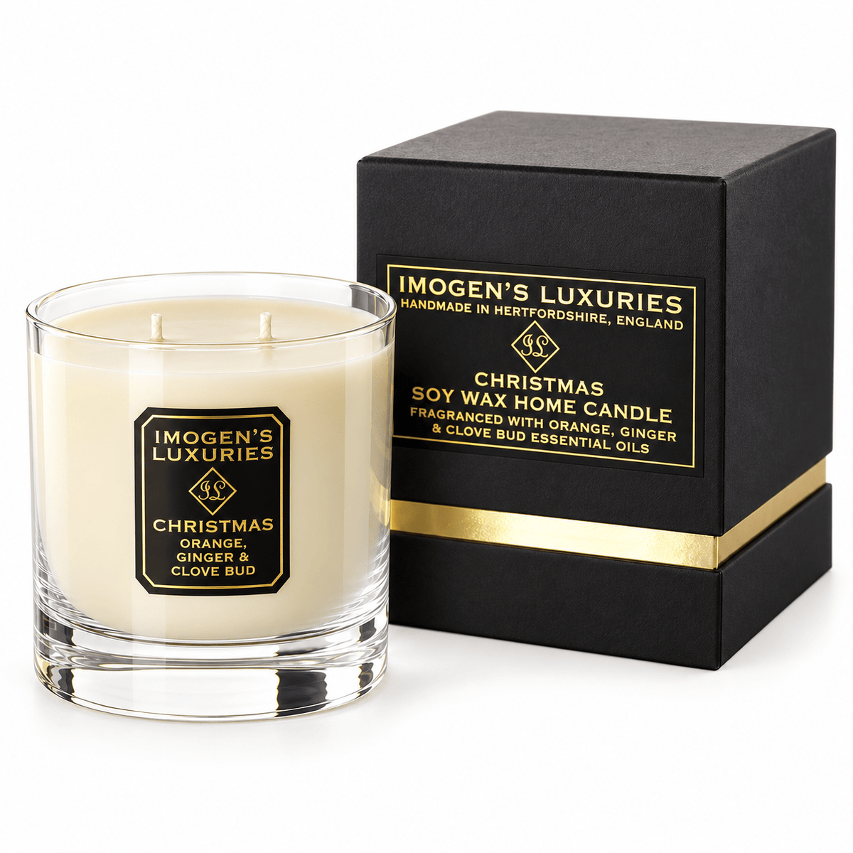 Cream coloured natural wax candle in glass container. Candles is scented with Orange, Cinnamon, Clove & Ginger Essential Oils. On the glass container is a black and gold label saying "Imogen's Luxuries" "Christmas". The candle sits by a solid black and gold shoulder box with a black and gold label saying "Handmade Natural Wax Candle fragranced with pure essential oils.