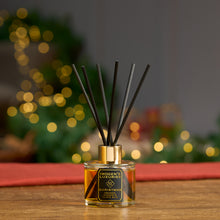 Christmas 100ml reed diffuser in clear bottle with 6 thick black reeds. Scented with Orange, Cinnamon, Clove and Ginger essential oils. Natural, vegan and cruelty free. Handmade by Imogen's Luxuries, Berkshire