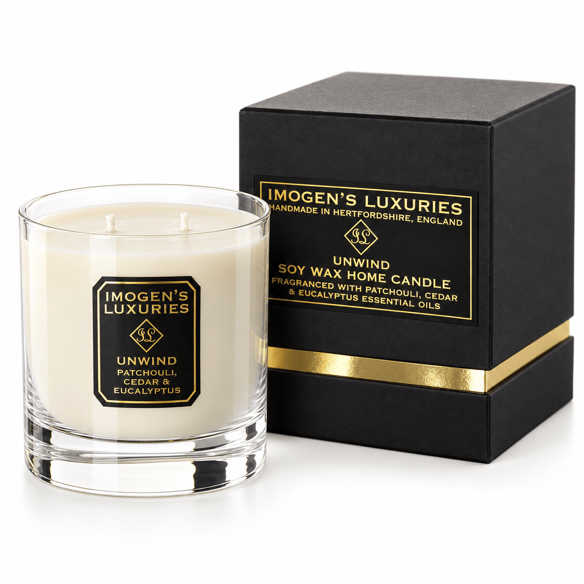 Cream coloured natural wax candle in glass container. Candles is scented with Patchouli, Cedarwood & Eucalyptus Essential Oils. On the glass container is a black and gold label saying "Imogen's Luxuries" "Unwind". The candle sits by a solid black and gold shoulder box with a black and gold label saying "Handmade Natural Wax Candle fragranced with pure essential oils.