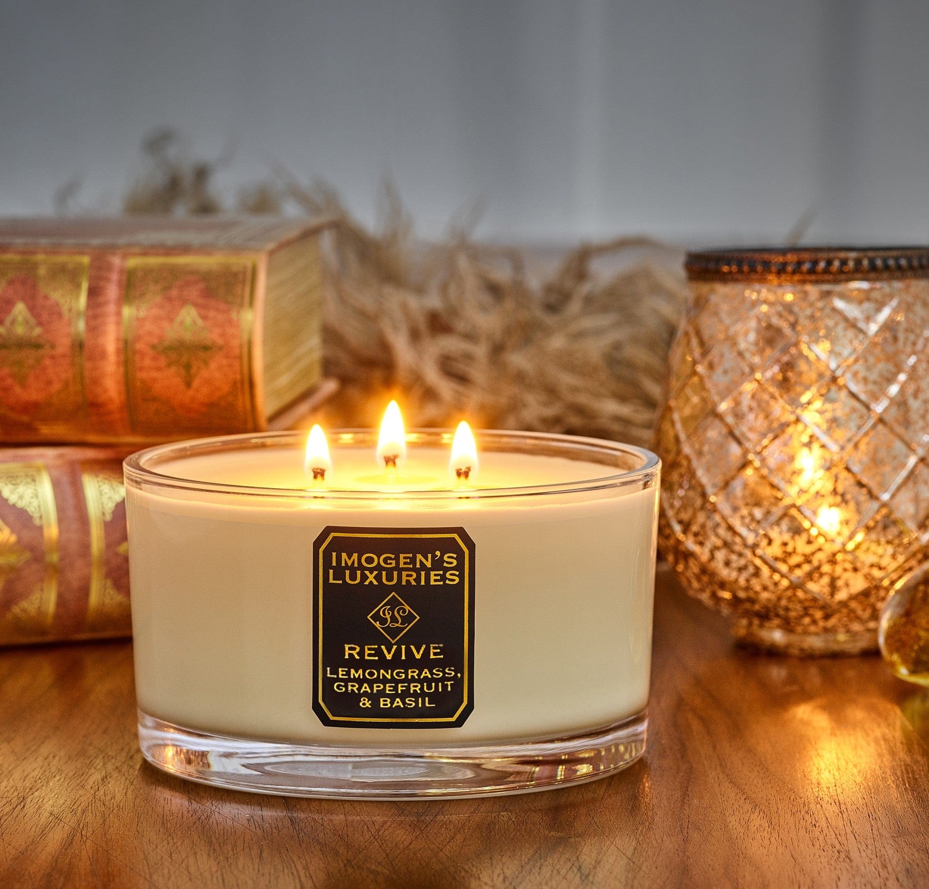 Revive luxury 3 wick aromatherapy candle is strongly scented with pure essential oils of Lemongrass, Grapefruit and Basil. Handmade with natural eco friendly rapeseed and coconut wax. An uplifting, crisp, citrus candle. Large 500g wax weight in a luxury Gift Box. Imogen's Luxuries, Berkshire, England