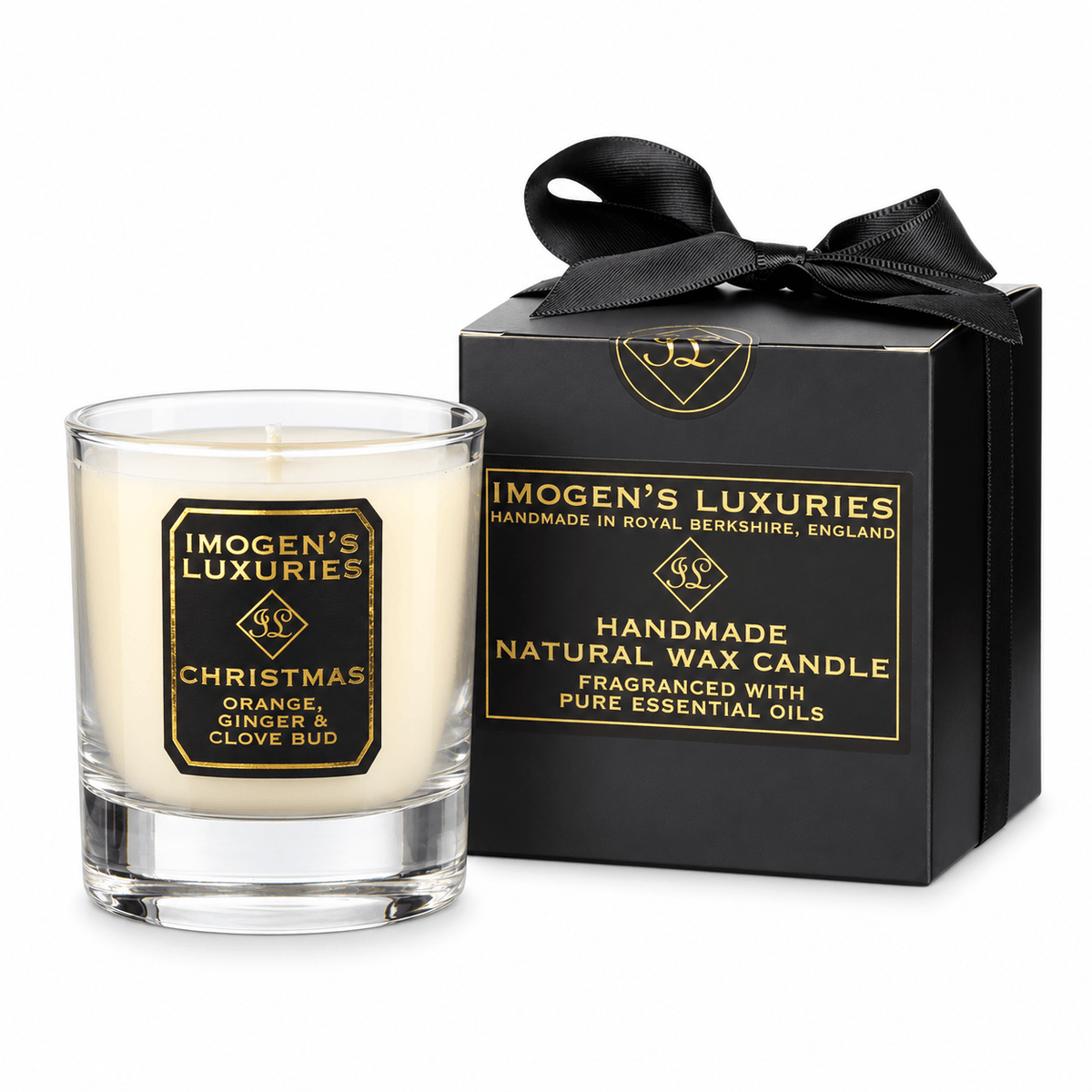 Christmas 1 wick soy wax candle scented with Orange, Cinnamon, Clove and Ginger essential Oils. Candle is cream in colour and in a glass container and is in front of anluxury black and gold gift box