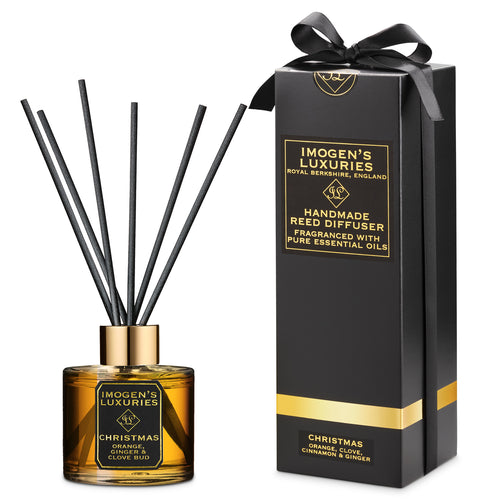 Christmas 100ml reed diffuser in gift box with a bow. Scented with our festive aromatherapy blend of Orange, Cinnamon, Clove & Ginger Essential Oils. Natural vegan and cruelty free. Handmade by Imogen's Luxuries, Berkshire, England.