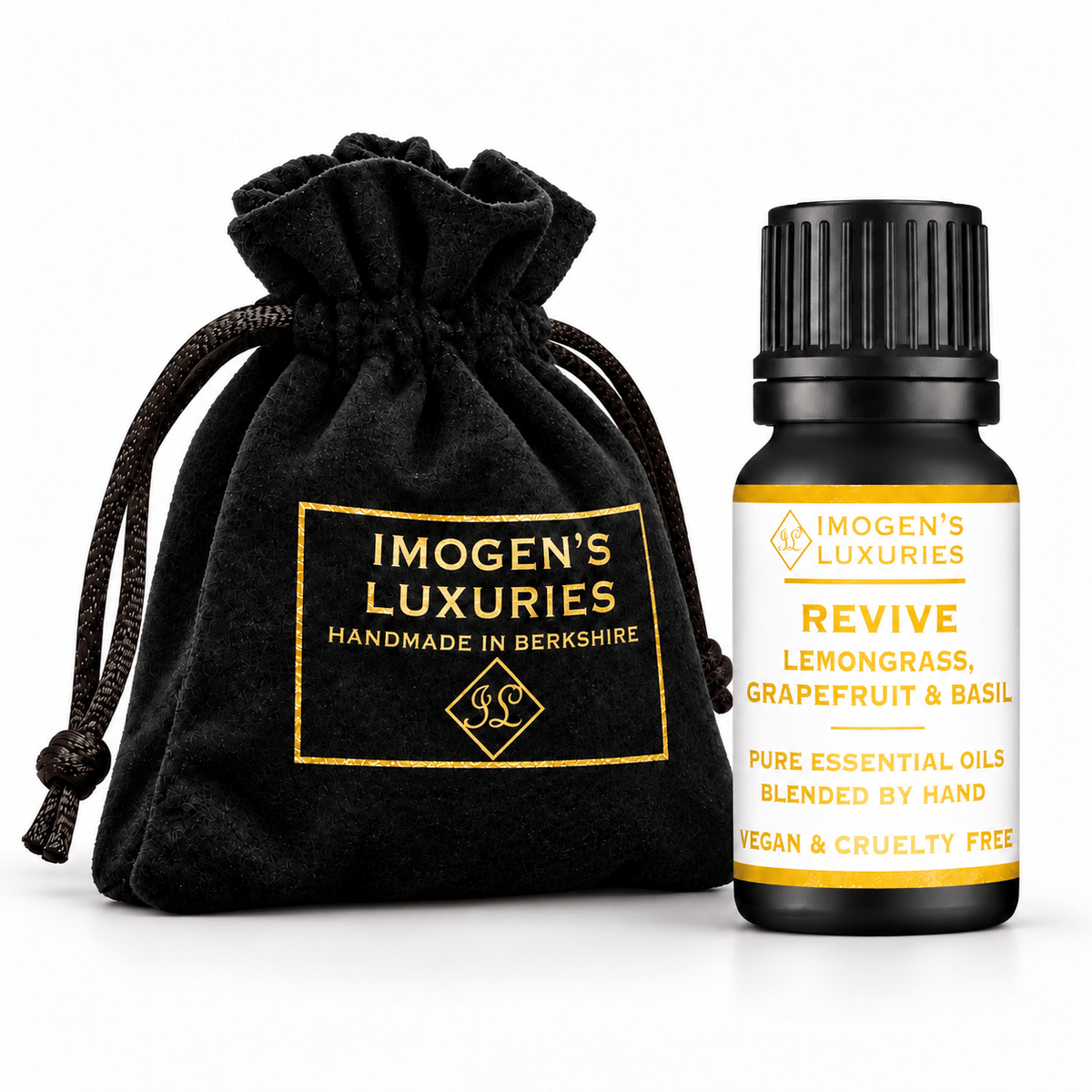 A 10ml black essential oil bottle with a black ribbed cap stands next to a black drawstring pouch. Both items are branded IMOGEN'S LUXURIES, with the pouch featuring gold lettering and the bottle featuring a white label with gold text. The label says "REVEIVE, LEMONGRASS, GRAPEFRUIT & BASIL PURE ESSENTIAL OILS.. BLENDED BY HAND. VEGAN AND CRUELTY FREE