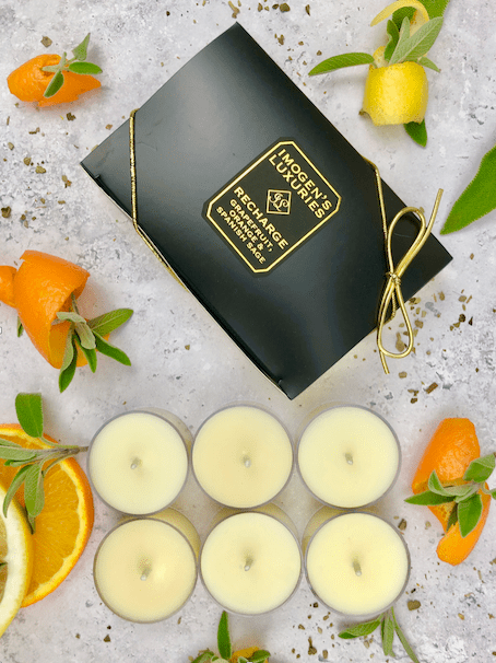 Recharge Tea lights scented with Grapefruit, Orange and Spanish Sage EssentialOils. Handmade with natural wax and free from paraffin wax and synthetic ingredients. Cruelty free and vegan. Pack of 6 in clear acrylic recyclable cups. Cruelty free and vegan. Imogen's Luxuries, Berkshire