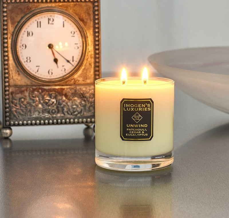 Unwind Home Candle burning: Fragranced with Patchouli, Cedar & Eucalyptus Essential Oils. Handpoured with 320g natural wax. £24
